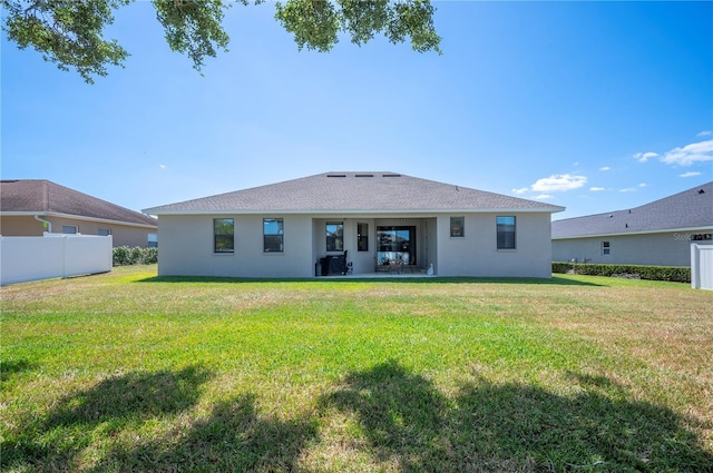 5531 Pebble Beach Dr, Lakeland, FL 33812 - back of house with a patio, stucco siding, a yard, and fence