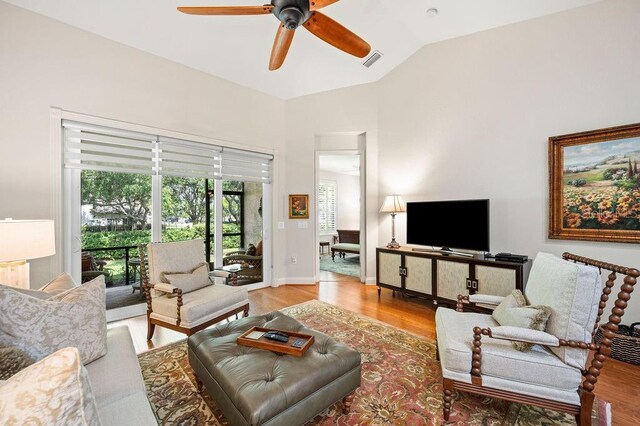 2965 Mission Lakes Dr, Lakeland, FL 33803 - living area featuring healthy amount of natural light, a ceiling fan, vaulted ceiling, and wood finished floors
