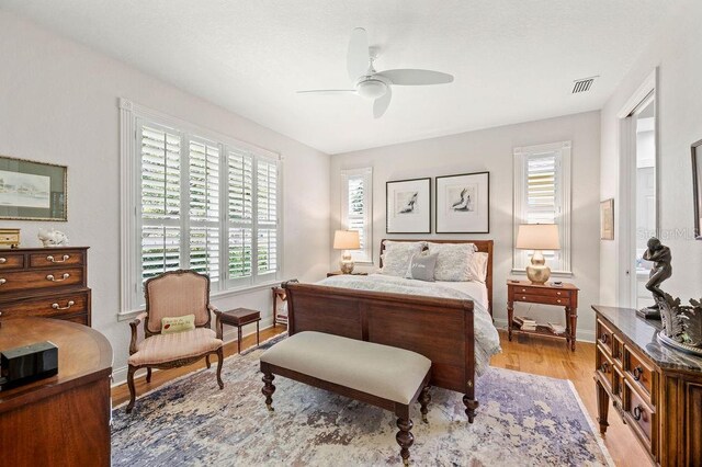 2965 Mission Lakes Dr, Lakeland, FL 33803 - bedroom with multiple windows, light wood finished floors, baseboards, and ceiling fan