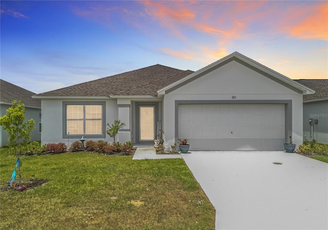 ranch-style house with roof with shingles, an attached garage, and stucco siding