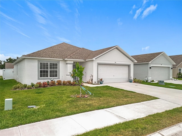 ranch-style house with roof with shingles, a front yard, concrete driveway, an attached garage, and stucco siding