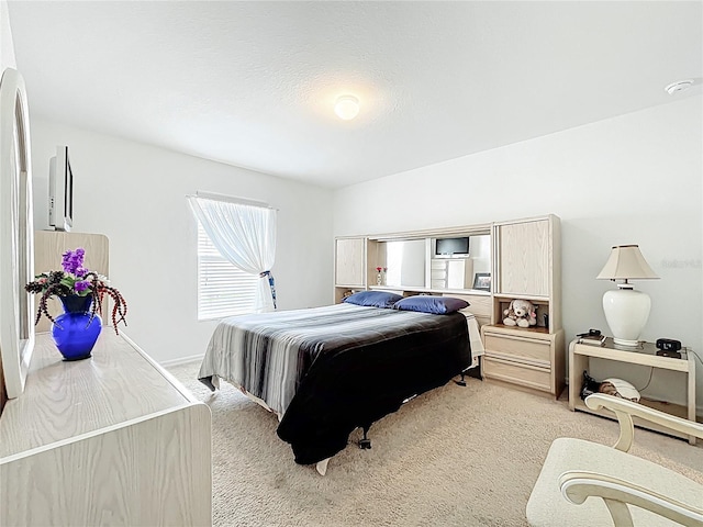 bedroom featuring light carpet