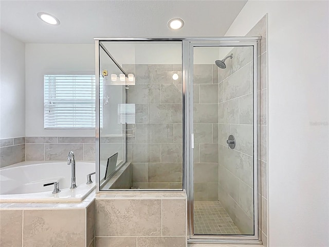 full bathroom with recessed lighting, a shower stall, and a garden tub