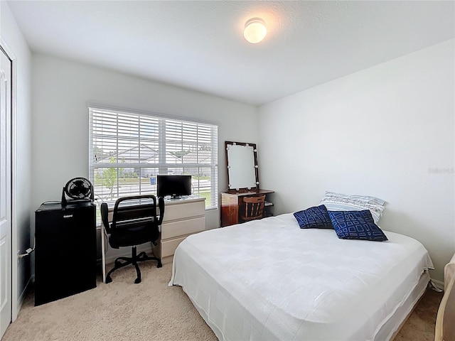 bedroom featuring light carpet