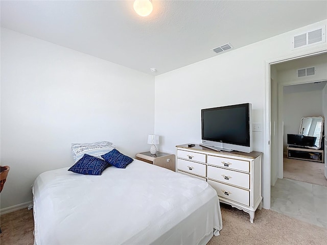 bedroom featuring light colored carpet and visible vents