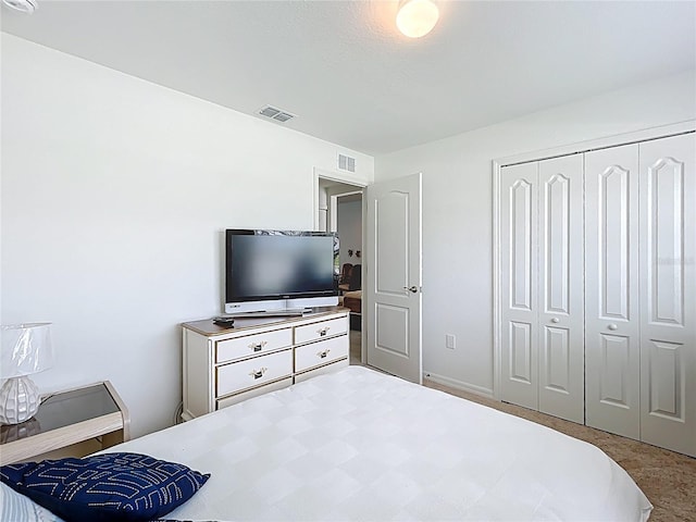 bedroom with carpet floors, a closet, and visible vents