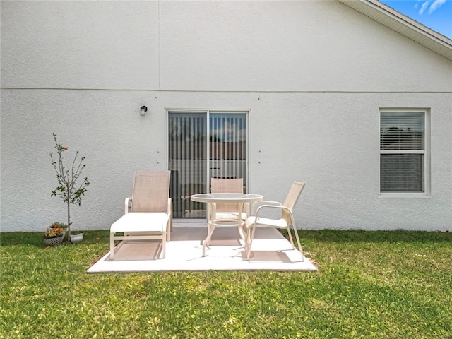 back of house featuring a yard and a patio area