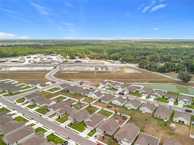 birds eye view of property featuring a residential view and a wooded view