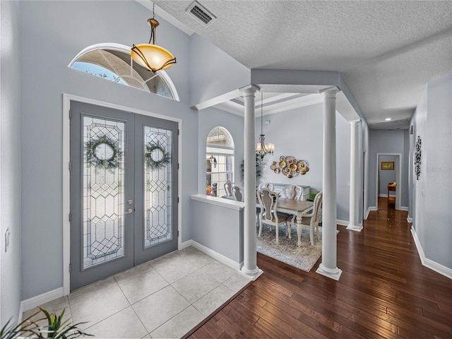 800 Osprey Landing Dr, Lakeland, FL 33813 - foyer with french doors, decorative columns, wood-type flooring, a chandelier, and baseboards