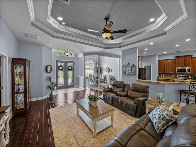 800 Osprey Landing Dr, Lakeland, FL 33813 - living area with crown molding, a raised ceiling, baseboards, a textured ceiling, and a ceiling fan