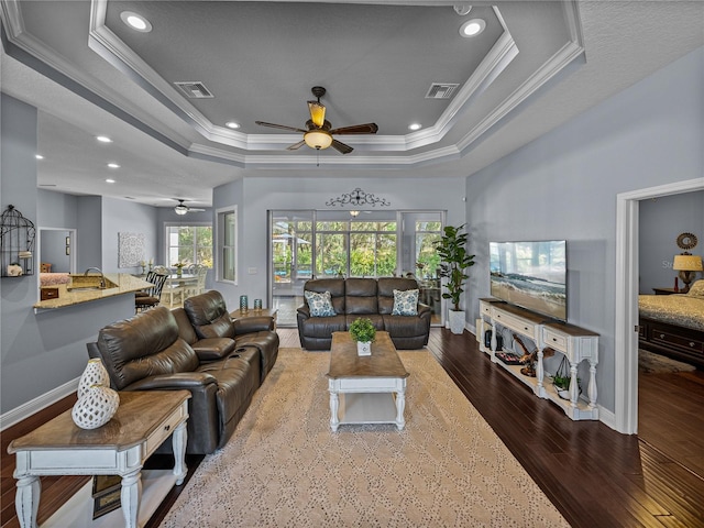 800 Osprey Landing Dr, Lakeland, FL 33813 - living area featuring a ceiling fan, ornamental molding, hardwood / wood-style flooring, a raised ceiling, and baseboards