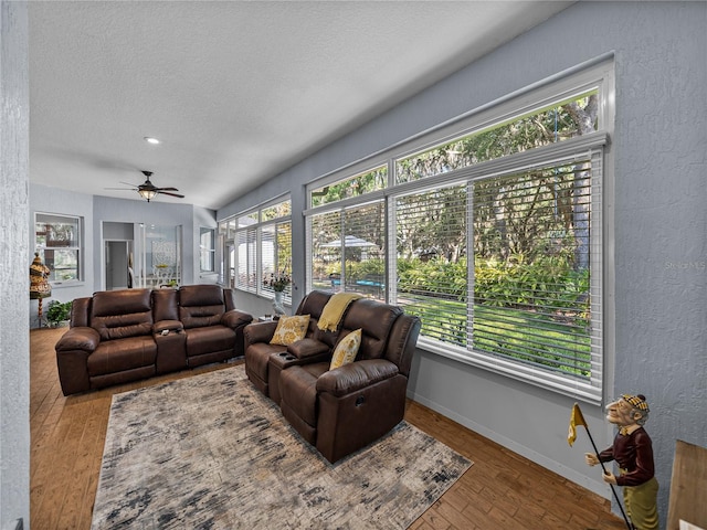 800 Osprey Landing Dr, Lakeland, FL 33813 - living room with a textured ceiling, a ceiling fan, hardwood / wood-style flooring, baseboards, and a textured wall
