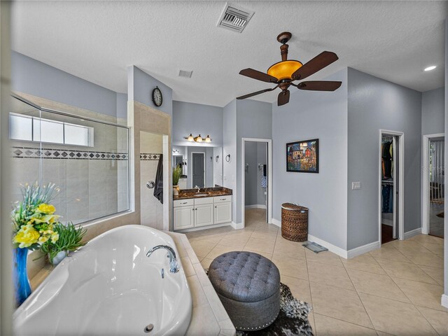 800 Osprey Landing Dr, Lakeland, FL 33813 - bathroom featuring a tub, a tile shower, ceiling fan, vanity, and tile patterned floors