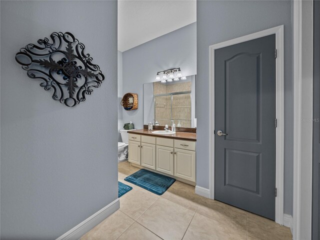 800 Osprey Landing Dr, Lakeland, FL 33813 - bathroom featuring vanity, baseboards, tile patterned flooring, toilet, and tiled shower