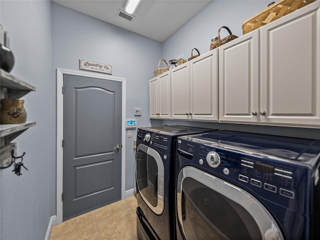 800 Osprey Landing Dr, Lakeland, FL 33813 - laundry area featuring cabinet space, washer and clothes dryer, baseboards, and light tile patterned floors