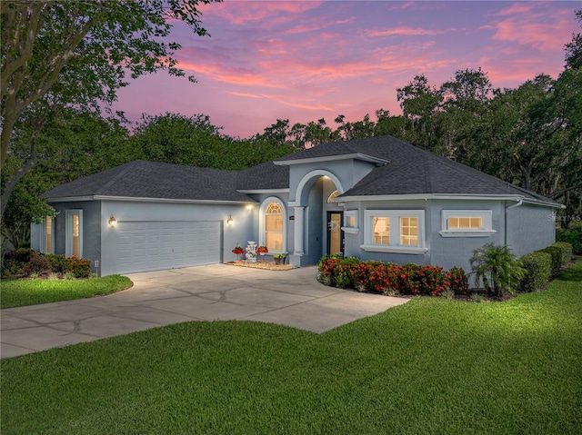 800 Osprey Landing Dr, Lakeland, FL 33813 - ranch-style home with stucco siding, a garage, a yard, roof with shingles, and concrete driveway