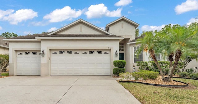 3592 Prescott Loop, Lakeland, FL 33810 - view of front of house featuring a garage, stucco siding, and concrete driveway