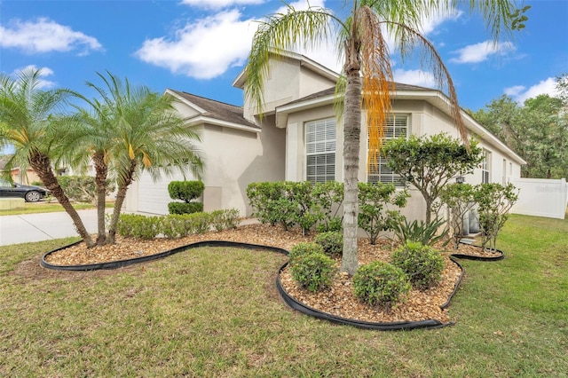 3592 Prescott Loop, Lakeland, FL 33810 - view of side of home with an attached garage, stucco siding, a yard, and concrete driveway