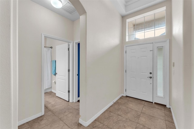 3592 Prescott Loop, Lakeland, FL 33810 - foyer with light tile patterned floors, baseboards, arched walkways, and visible vents