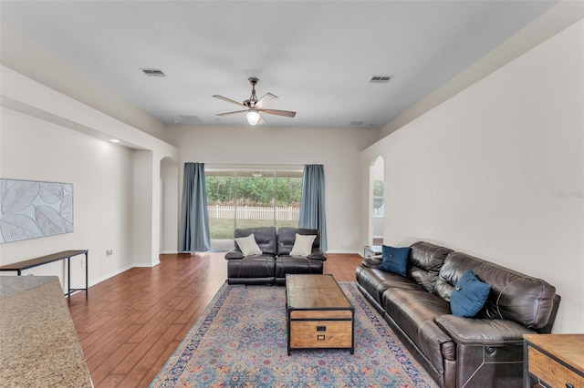 3592 Prescott Loop, Lakeland, FL 33810 - living room featuring a ceiling fan, visible vents, arched walkways, baseboards, and hardwood / wood-style floors
