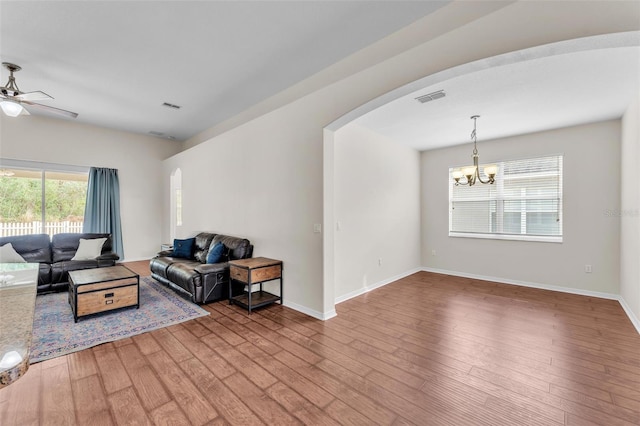 3592 Prescott Loop, Lakeland, FL 33810 - living area featuring visible vents, arched walkways, ceiling fan with notable chandelier, and wood finished floors