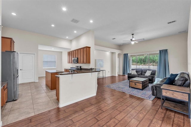 3592 Prescott Loop, Lakeland, FL 33810 - kitchen with visible vents, a peninsula, open floor plan, a ceiling fan, and appliances with stainless steel finishes