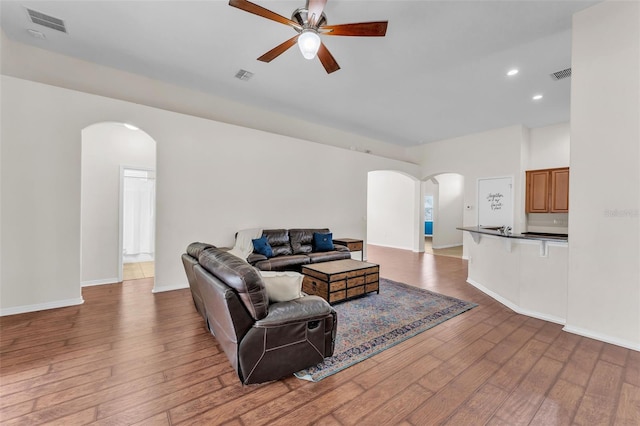3592 Prescott Loop, Lakeland, FL 33810 - living area with arched walkways, wood-type flooring, ceiling fan, and visible vents