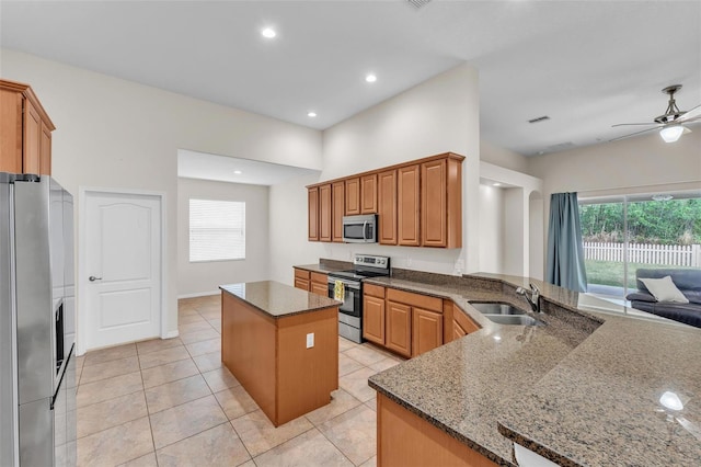 3592 Prescott Loop, Lakeland, FL 33810 - kitchen with a ceiling fan, a center island, dark stone counters, a sink, and stainless steel appliances