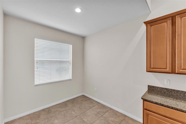 3592 Prescott Loop, Lakeland, FL 33810 - unfurnished dining area featuring baseboards and light tile patterned floors