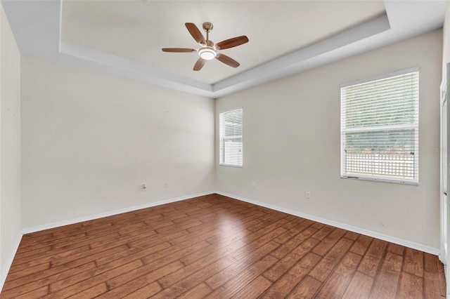3592 Prescott Loop, Lakeland, FL 33810 - empty room featuring wood-type flooring, ceiling fan, baseboards, and a raised ceiling