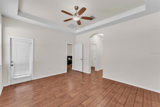 3592 Prescott Loop, Lakeland, FL 33810 - spare room with baseboards, arched walkways, a ceiling fan, and a tray ceiling