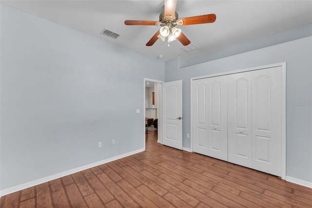3592 Prescott Loop, Lakeland, FL 33810 - unfurnished bedroom featuring wood finished floors, a ceiling fan, a closet, visible vents, and baseboards