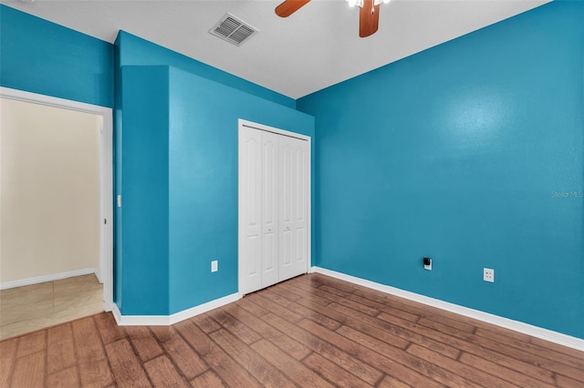 3592 Prescott Loop, Lakeland, FL 33810 - unfurnished bedroom featuring visible vents, a closet, wood finished floors, baseboards, and a ceiling fan