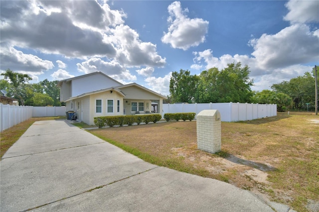 single story home featuring fence, driveway, and a front lawn