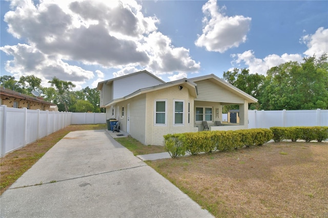 view of side of home featuring a fenced backyard, a patio, and concrete driveway