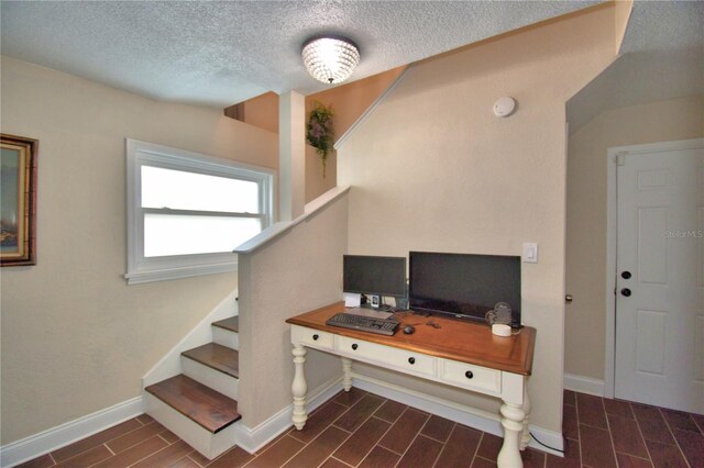 home office with baseboards, wood finish floors, and a textured ceiling