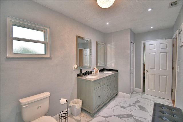 bathroom featuring visible vents, marble finish floor, toilet, recessed lighting, and a sink