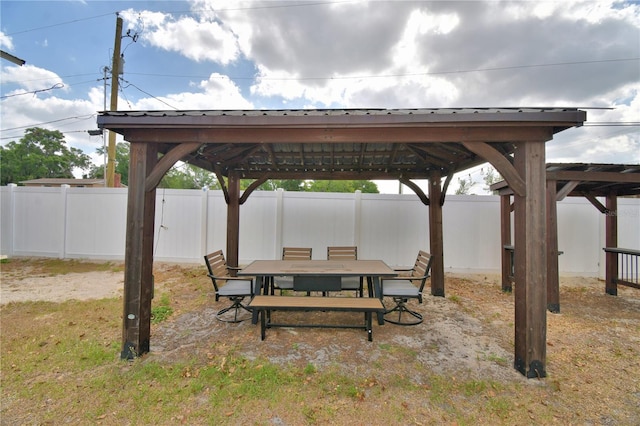 view of patio / terrace with fence, outdoor dining area, and a gazebo