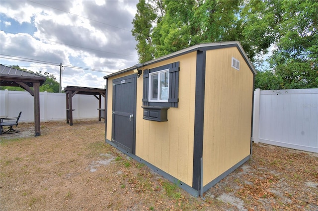 view of shed with a gazebo and a fenced backyard
