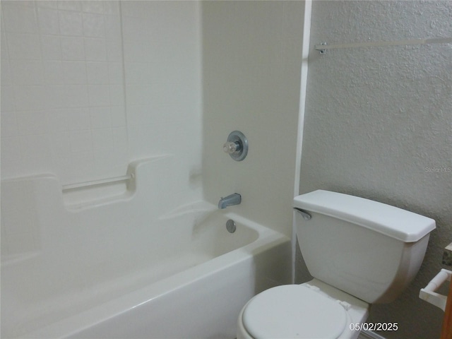 bathroom featuring toilet and tub / shower combination