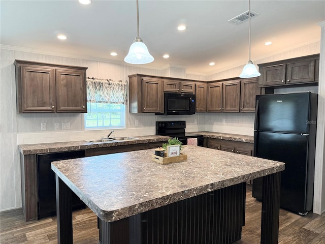 1619 N Lone Bay Blvd, Avon Park, FL 33825 - kitchen with black appliances, dark brown cabinetry, ornamental molding, a kitchen island, and dark wood-style flooring