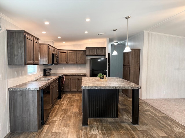 1619 N Lone Bay Blvd, Avon Park, FL 33825 - kitchen with black appliances, ornamental molding, a kitchen island, dark wood-type flooring, and dark brown cabinets