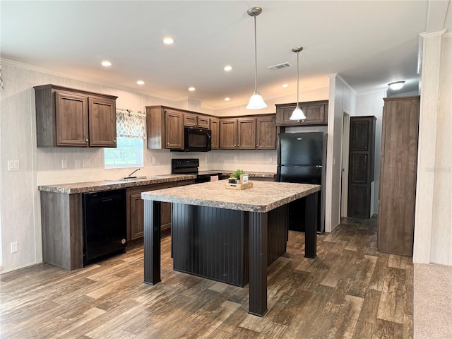 1619 N Lone Bay Blvd, Avon Park, FL 33825 - kitchen with black appliances, dark wood-type flooring, crown molding, a kitchen island, and a kitchen breakfast bar