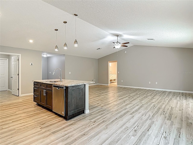 kitchen with a sink, ceiling fan, stainless steel dishwasher, light wood-style flooring, and a textured ceiling
