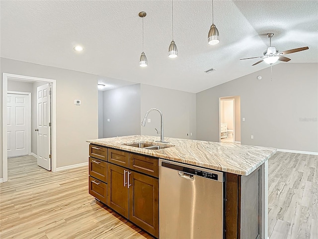kitchen with stainless steel dishwasher, a sink, light wood-style flooring, a ceiling fan, and an island with sink