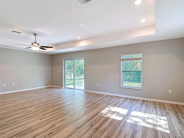 unfurnished room featuring light wood finished floors, baseboards, recessed lighting, ceiling fan, and a textured ceiling