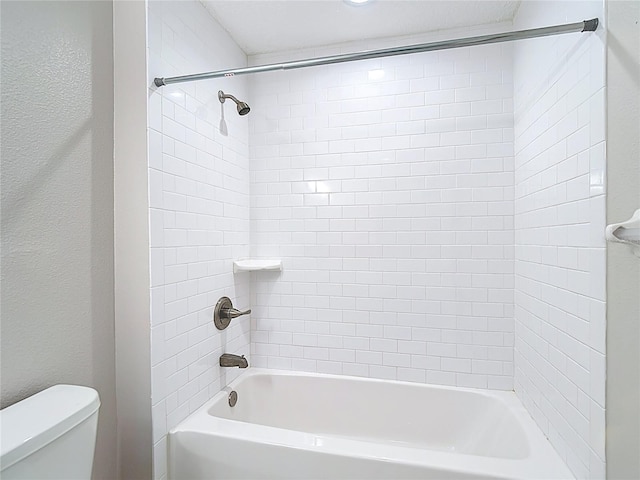bathroom with toilet and bathtub / shower combination