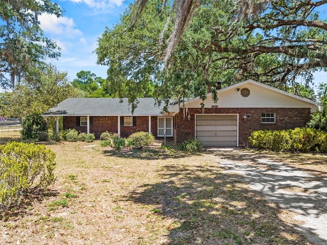 3441 Sherertz Rd, Lakeland, FL 33810 - ranch-style home featuring an attached garage, brick siding, and dirt driveway