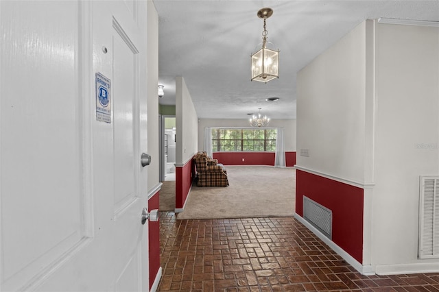 3441 Sherertz Rd, Lakeland, FL 33810 - foyer entrance featuring a chandelier, brick patterned floors, baseboards, and dark carpet