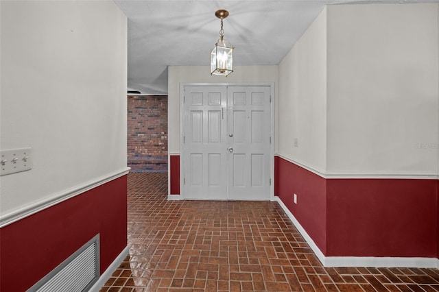 3441 Sherertz Rd, Lakeland, FL 33810 - foyer featuring brick patterned flooring and baseboards